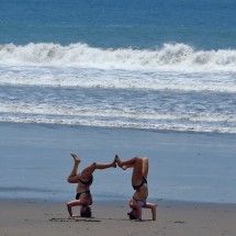 Two girls exercising in front of the Pacific Ocean
